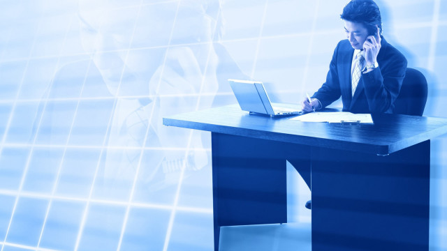 Man sitting desk laptop phone free wallpaper - medium preview image