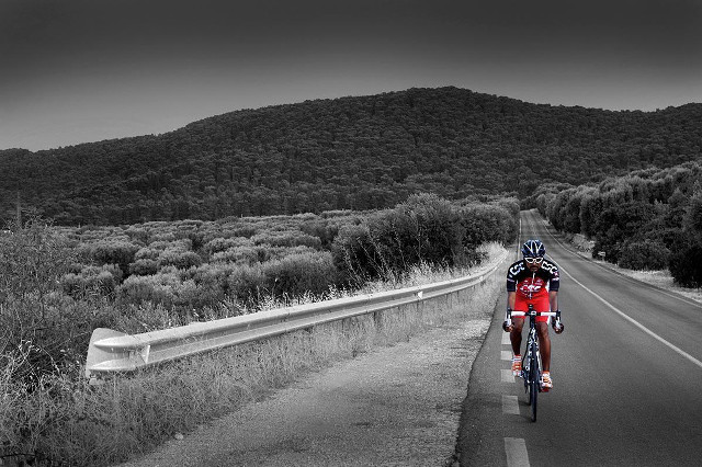 Man riding bike road green free wallpaper - medium preview image