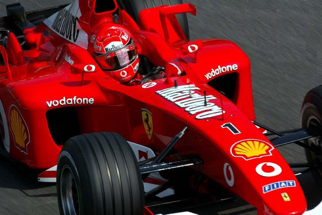 Man driving red race car free wallpaper - medium preview image