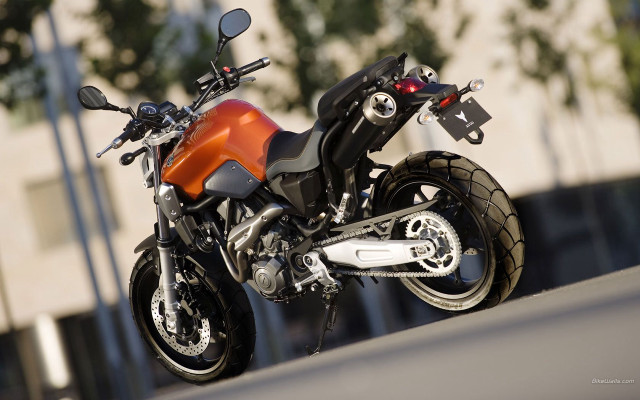 Motorcycle parked road building tree free wallpaper - medium preview image