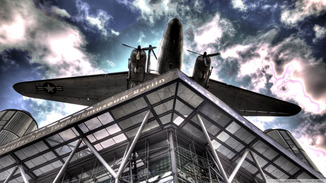 Plane on building sky background free wallpaper - medium preview image