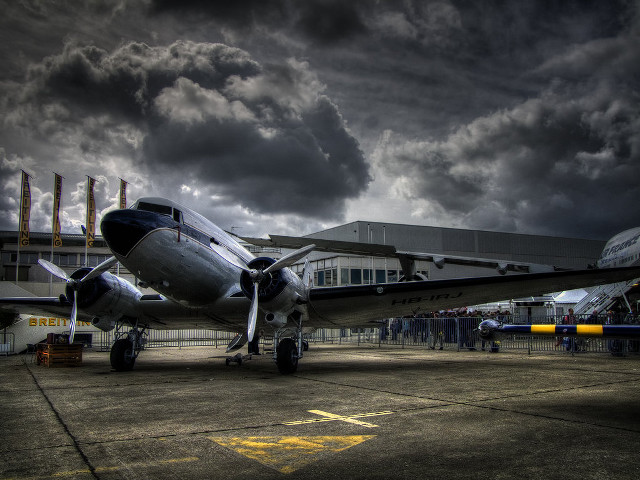 Plane parked tarmac cloudy sky free wallpaper - medium preview image