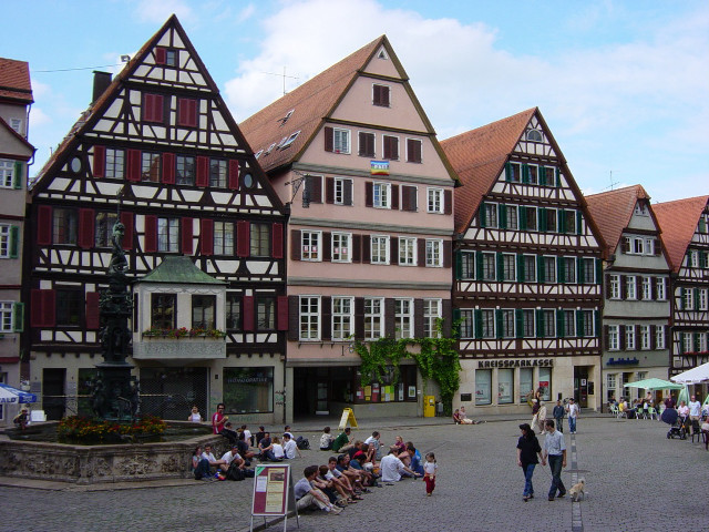 Group people stone walkway buildings free wallpaper - medium preview image