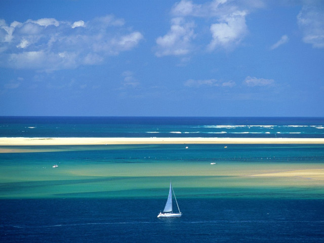 Sailboat floating ocean sky clouds free wallpaper - medium preview image