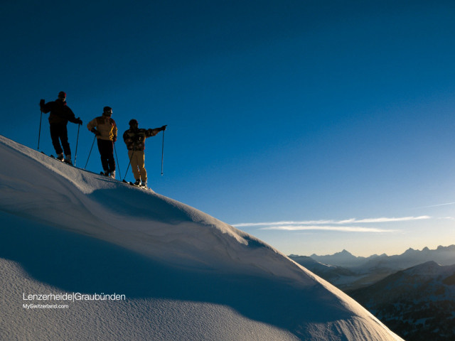 Three people snow covered slope free wallpaper - medium preview image