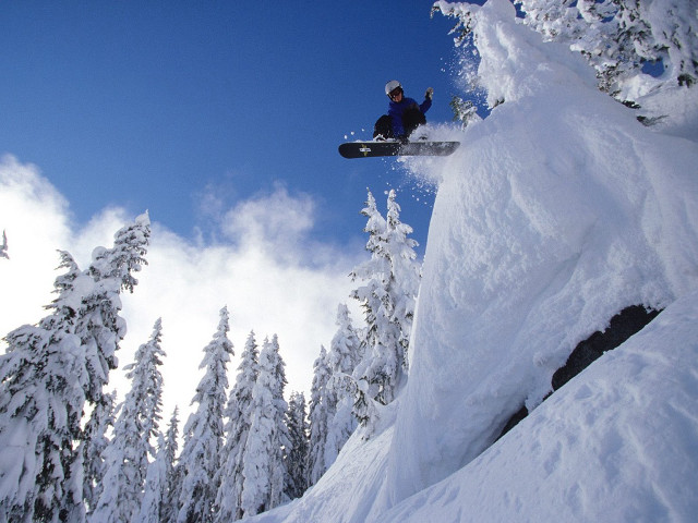 Snowboarder jump snowy mountain trees free wallpaper - medium preview image