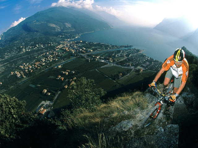 Man bike hill green hillside #4 free wallpaper - medium preview image