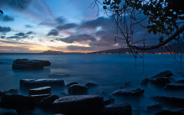 Water rocks city distance clouds free wallpaper - medium preview image