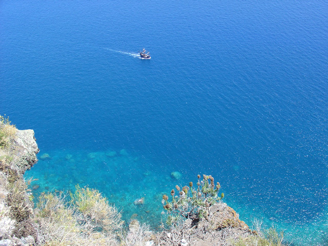 Boat cliff ocean water blue free wallpaper - medium preview image