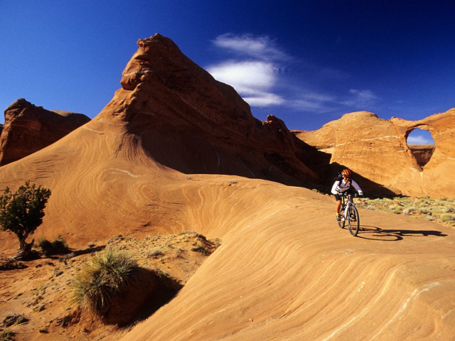 Man riding bike desert mountains free wallpaper - medium preview image