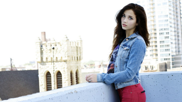 Woman leaning wall city background #2 free wallpaper - medium preview image