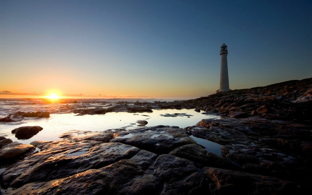 Lighthouse rocky shore sunset sun free wallpaper - medium preview image