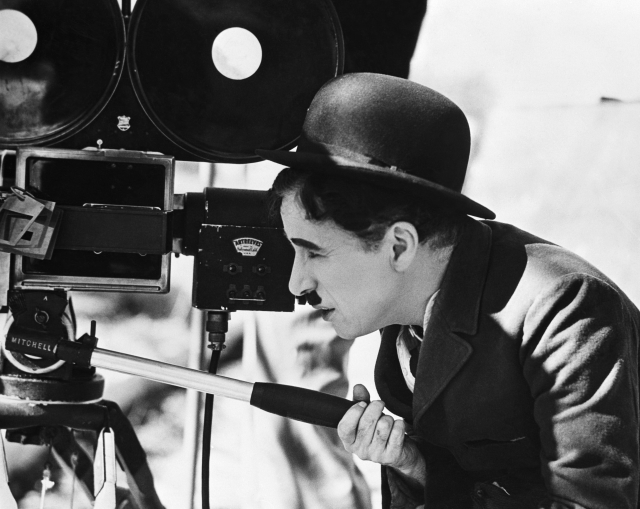 Man hat looking camera tripod free wallpaper - medium preview image