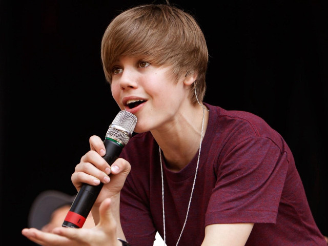 Boy holding microphone singing smiling free wallpaper - medium preview image