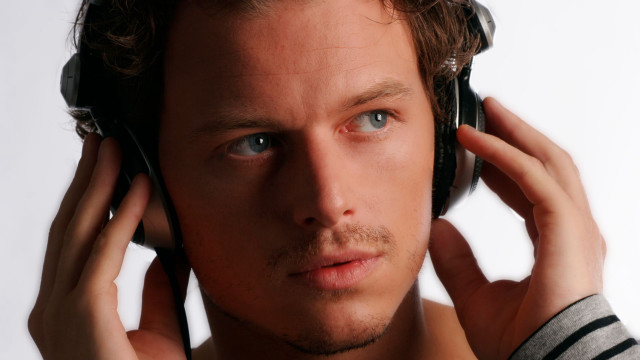 Man headphones serious look camera free wallpaper - medium preview image