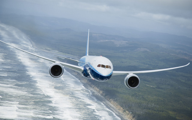 Jetliner hillside ocean cloudy sky free wallpaper - medium preview image
