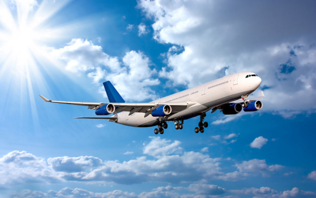 Jetliner flying blue sky sunbeams free wallpaper - medium preview image