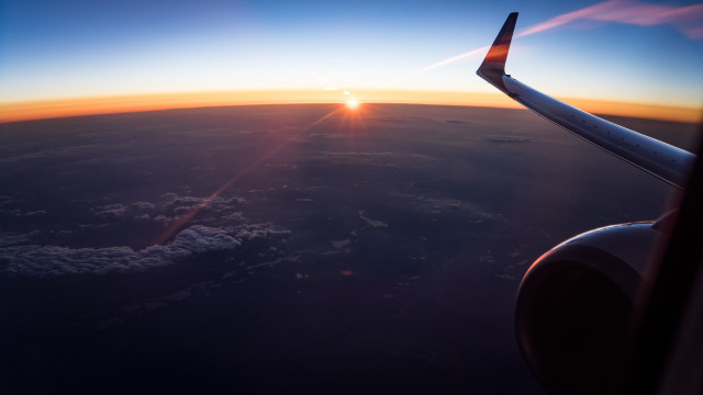 Sunset over clouds airplane wing free wallpaper - medium preview image