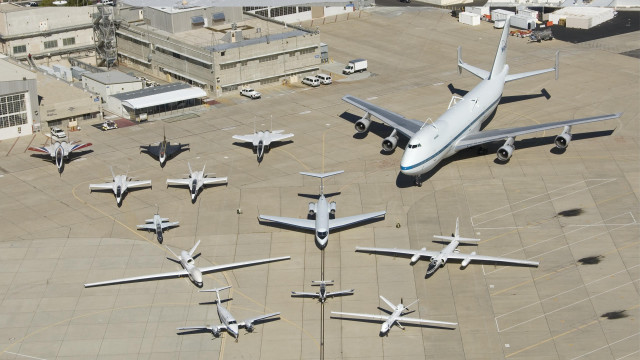 Airplanes runway lot building middle free wallpaper - medium preview image