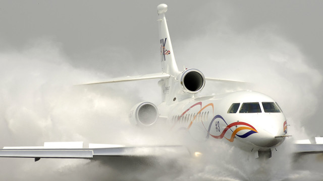 Jetliner cloudy sky runway smoke #2 free wallpaper - medium preview image
