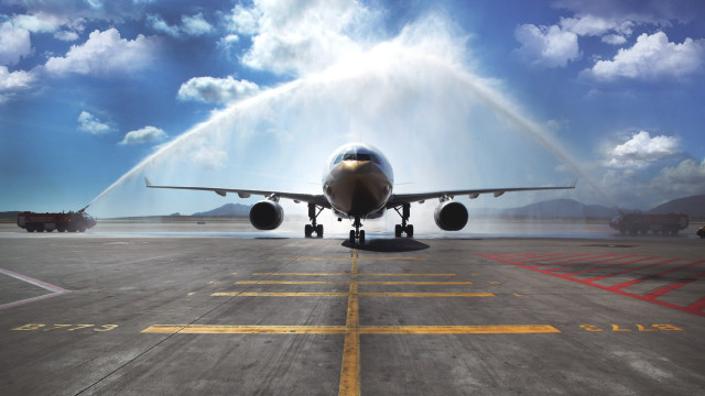 Jet airplane spraying water tarmac free wallpaper - medium preview image