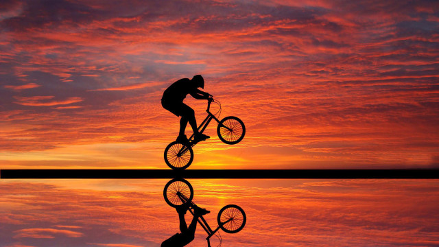 Man riding bike lake sunset free wallpaper - medium preview image