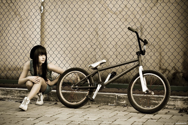 Woman bike sidewalk fence chain free wallpaper - medium preview image