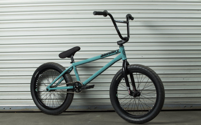 Blue bike leaning against wall free wallpaper - medium preview image