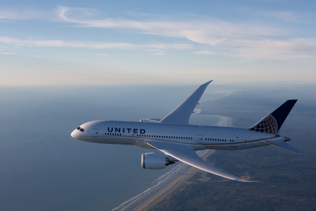 United airplane over ocean sunny free wallpaper - medium preview image