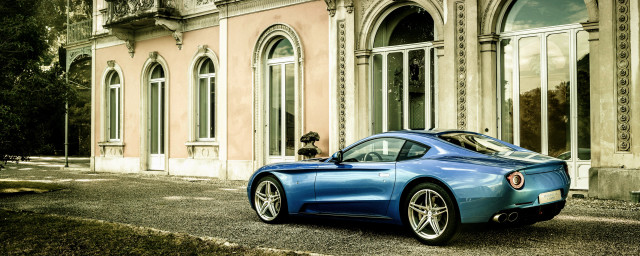 Blue sports car clocktower building free wallpaper - medium preview image