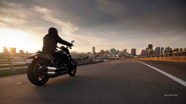 Man motorcycle city skyline sunset free wallpaper - medium preview image