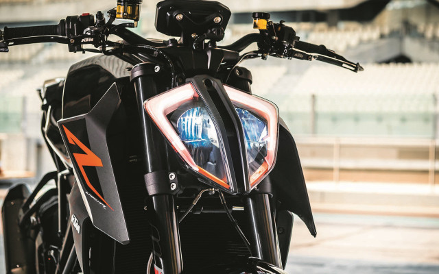 Motorcycle closeup headlight building background free wallpaper - medium preview image