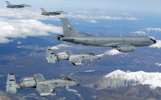 Military planes flying mountain range 2 - a plane in the foreground free wallpaper