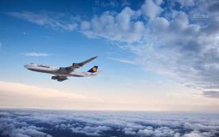 Jetliner flying cloudy blue sky - a jet free wallpaper