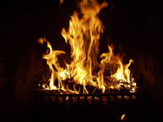 Blazing fireplace bright yellow flames - a fireplace free wallpaper