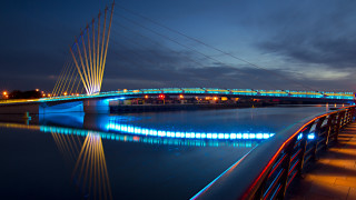 Lit bridge night water background - moody free wallpaper