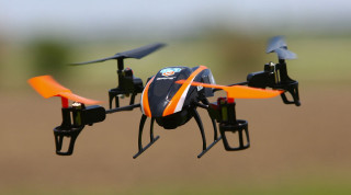 Small orange black flying drone - cybernetic free wallpaper