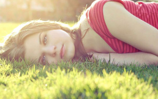 Woman smiling laying ongrass redshirt - eszter mattioni free wallpaper