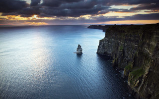 Ship sailing ocean cliff sunset - a ship free wallpaper
