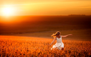 Woman field arms outstretched sunset - a woman in a field free wallpaper