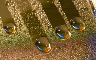 Metal water drops blue gold - a close up of a metal surface free wallpaper