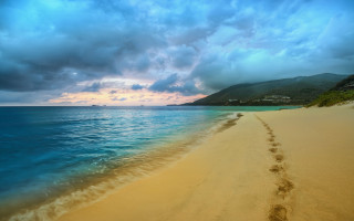 Beach footprints water mountain clouds - beach free wallpaper