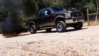 Black truck dirt road forest 2 - a forest of trees and bushes free wallpaper