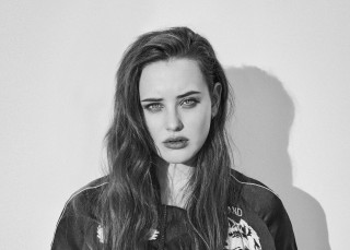 Woman long hair jacket pose - a white wall behind her free wallpaper