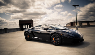 Black sports car cloudy sky 3 - a parking lot free wallpaper