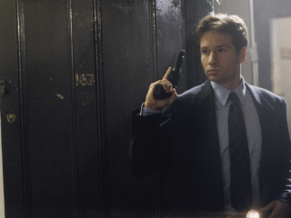 Man suit gun mirror camera - a man in a suit holding free wallpaper