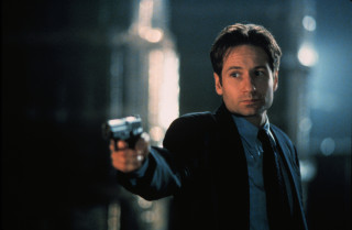 Man holding gun dark room - the wall free wallpaper