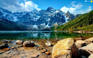Mountain lake rocks trees foreground - auseklis ozol free wallpaper