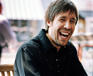 Smiling man outside table food - a plate of food in front free wallpaper