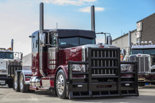 Red semi truck parking lot 3 - a red semi truck free wallpaper